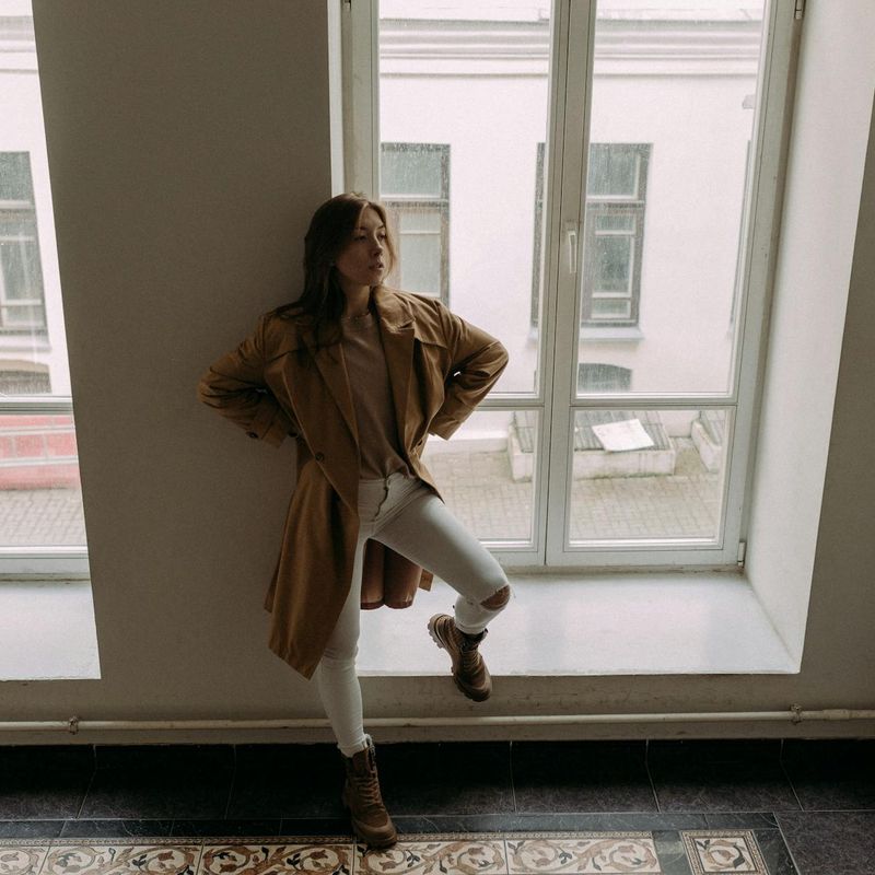 Silhouette of a man in a focused pose against a bright background.